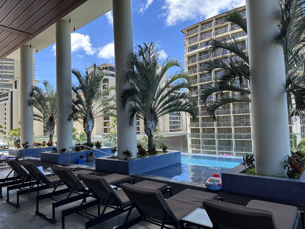 Loungers located by the infinity pool at the Trump International Hotel Waikiki.